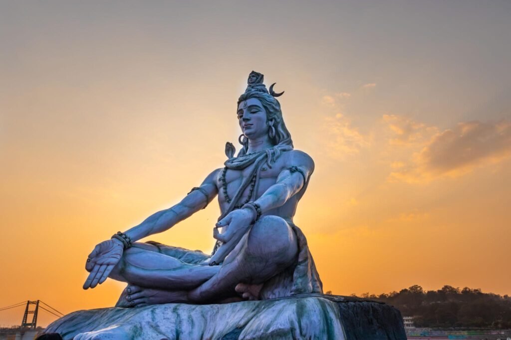 Lord Shiva meditation statue under starry night sky symbolizing yogic energy on Mahashivratri